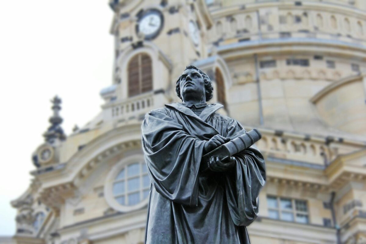 Close-up of Martin Luther statue in front of the iconic Frauenkirche in Dresden, Germany.
